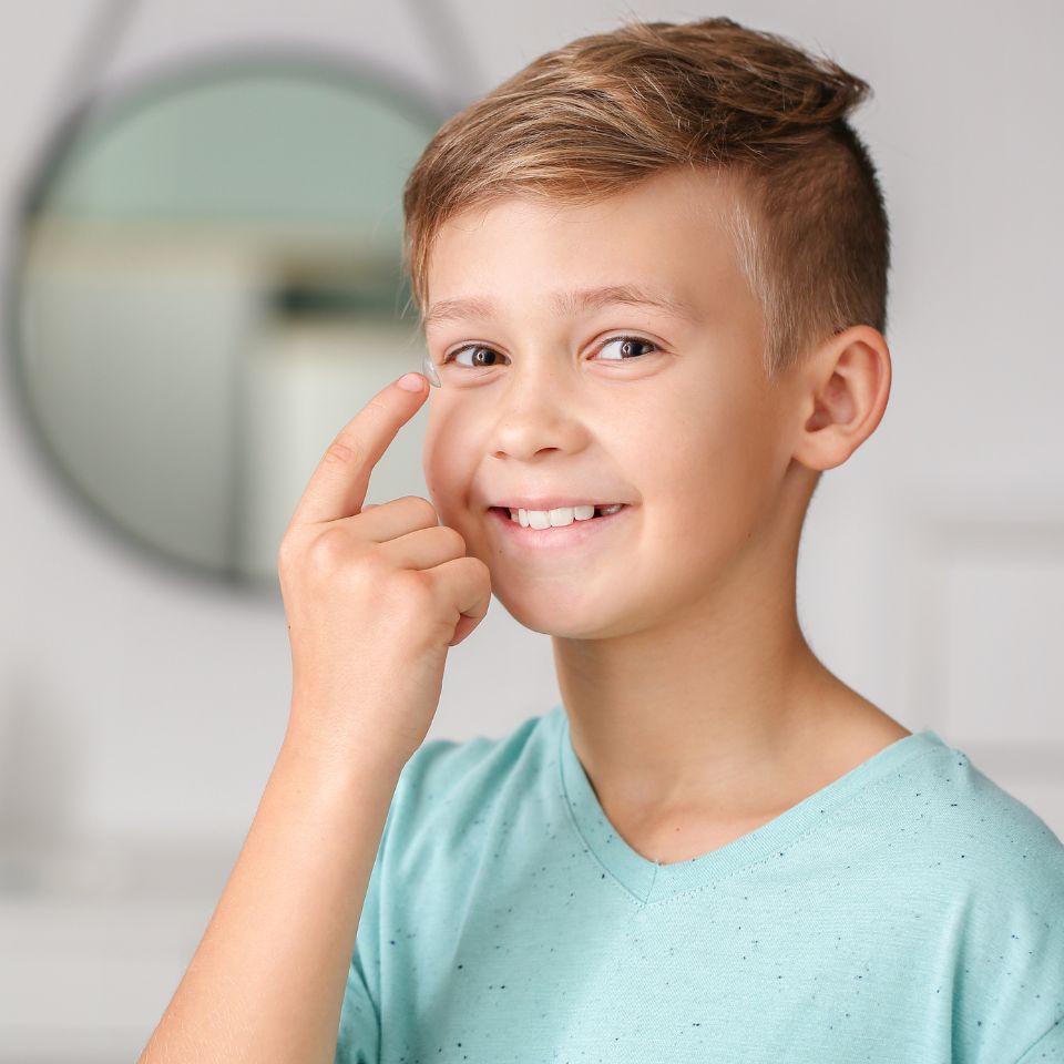 boy putting contacts in